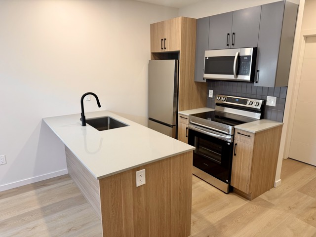 Kitchen with peninsula and stainless steel appliances