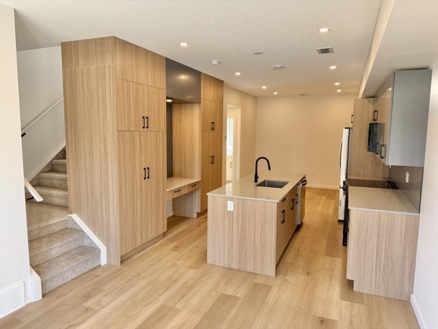 Main floor with built-in cabinetry, desk nook and staircase